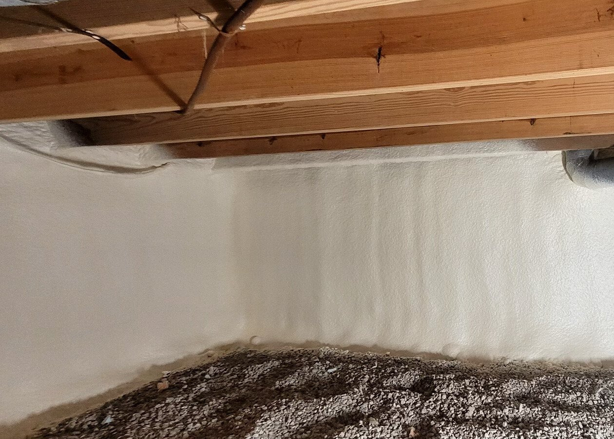 Crawl space walls insulated with foam and vapor barrier in Midwest home